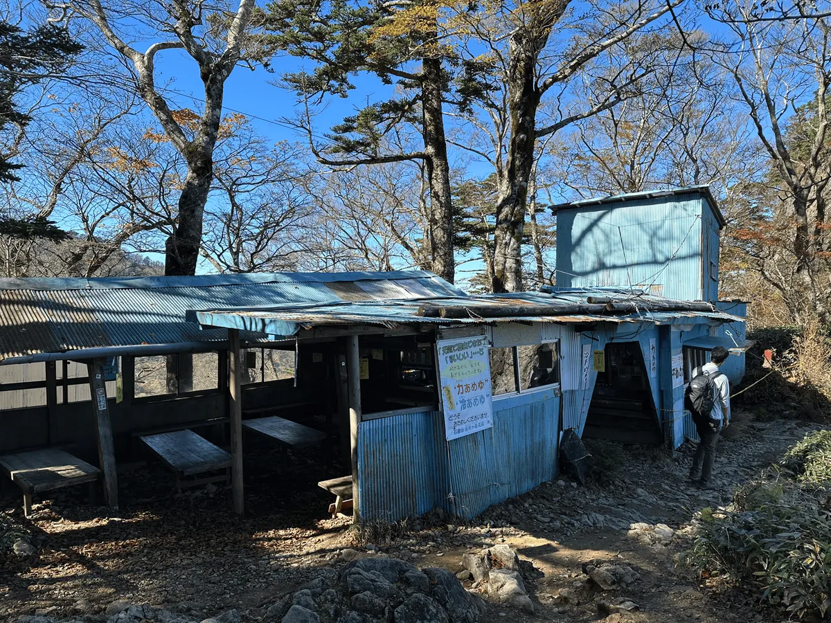 A shack made out of corrugated iron, painted blue.