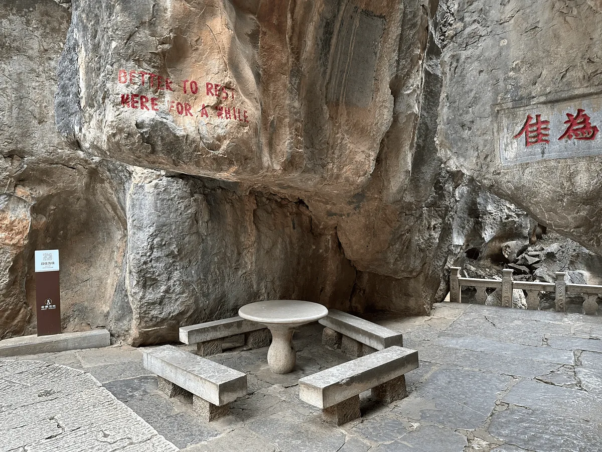 Stone rest area with English text carved into the rock