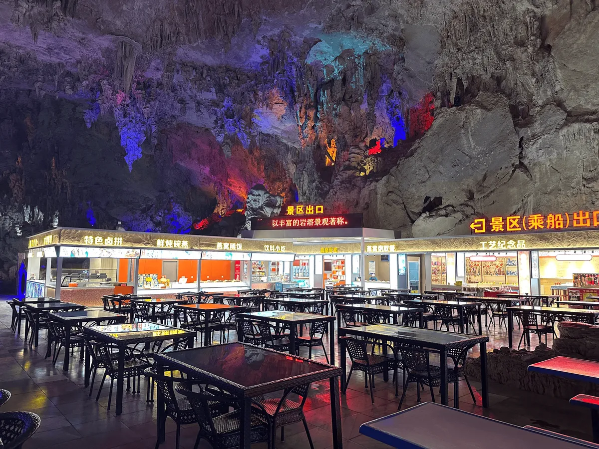 Illuminated food court area inside the cave