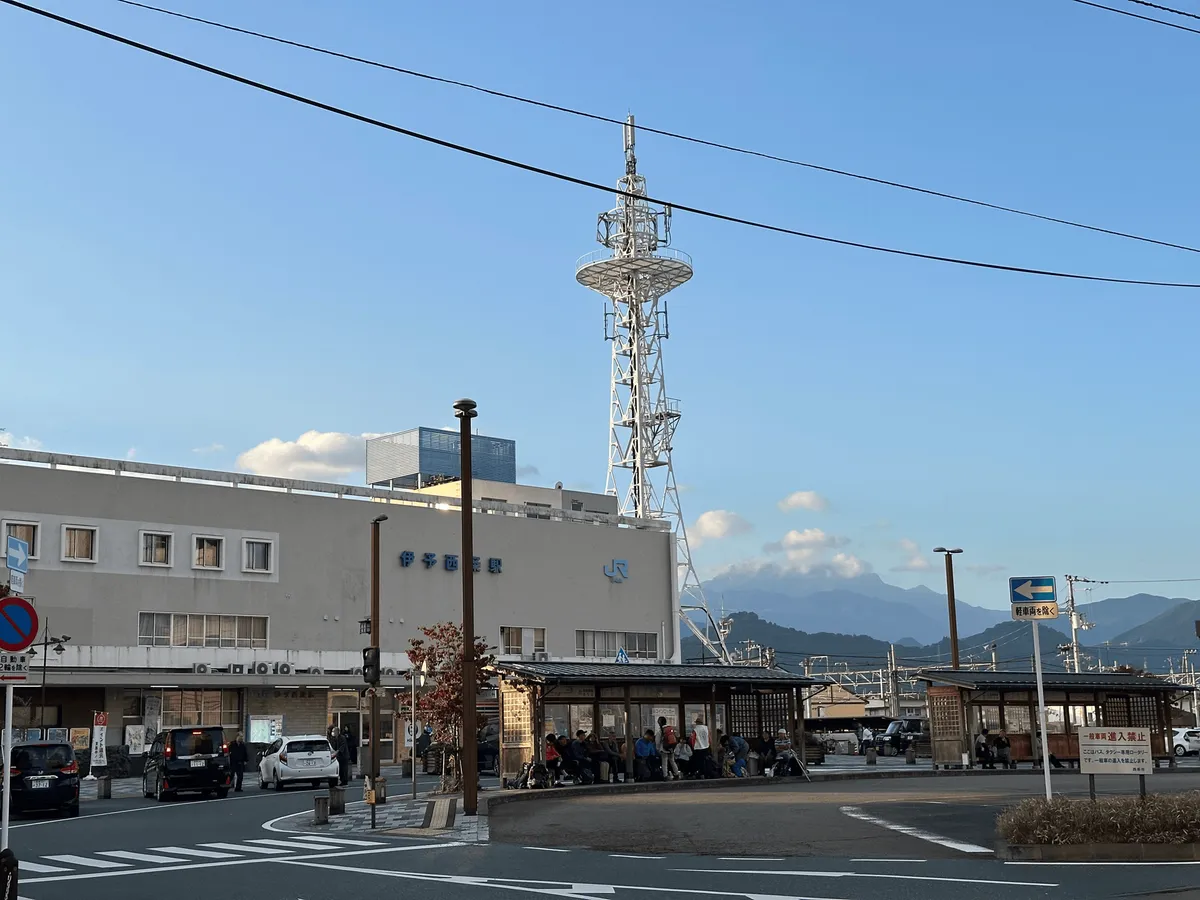 The bus stop in front of JR Iyo-Saijo station. Mt Isuzuchi partially visible in the background.