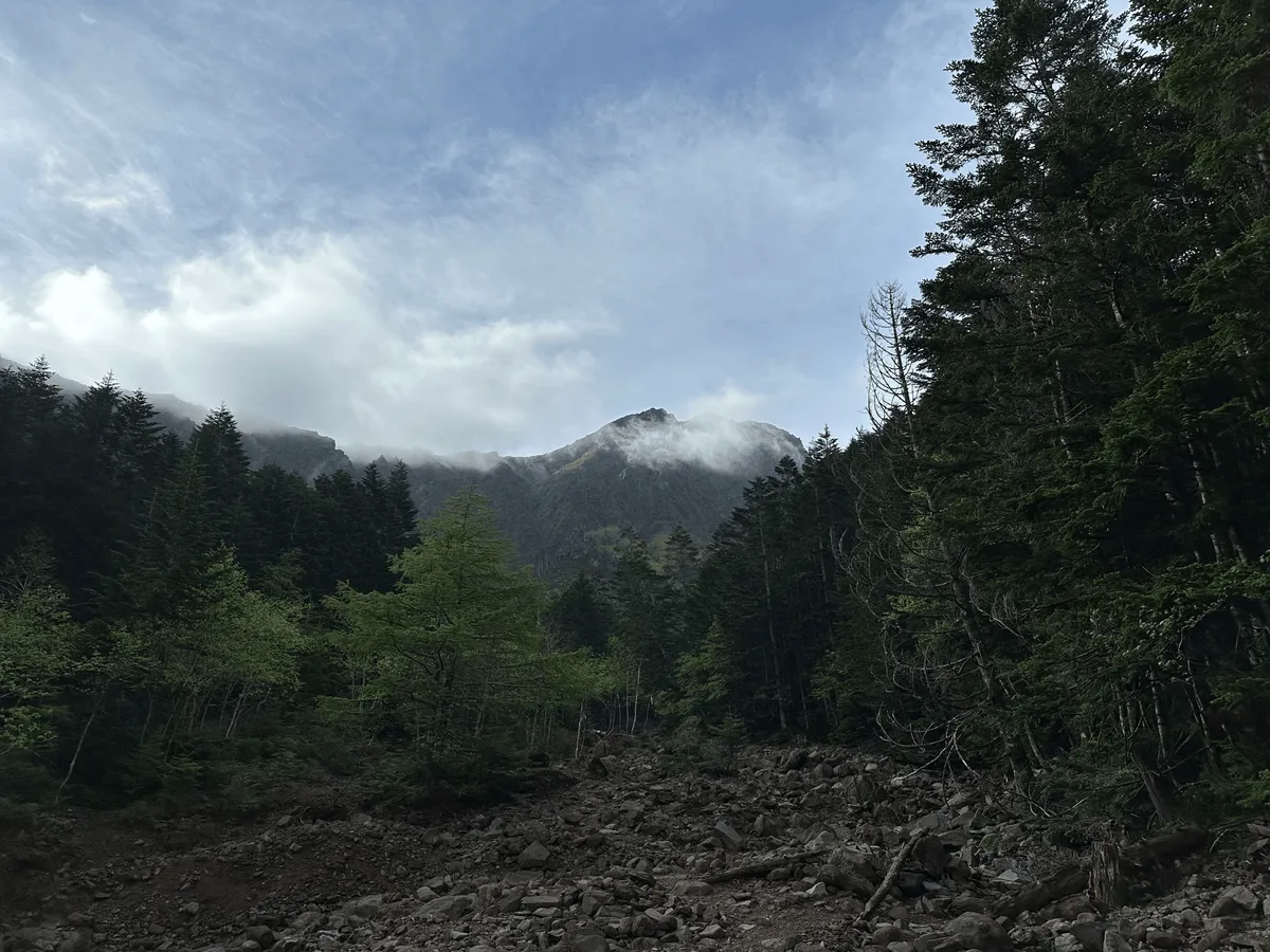 A mountain peak, half-visible behind the fog.