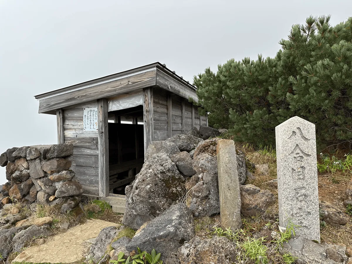 Wooden emergency shelter, with an open door.