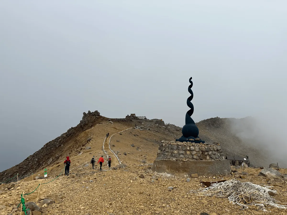 A statue - a weird black spiral with a sphere at the base