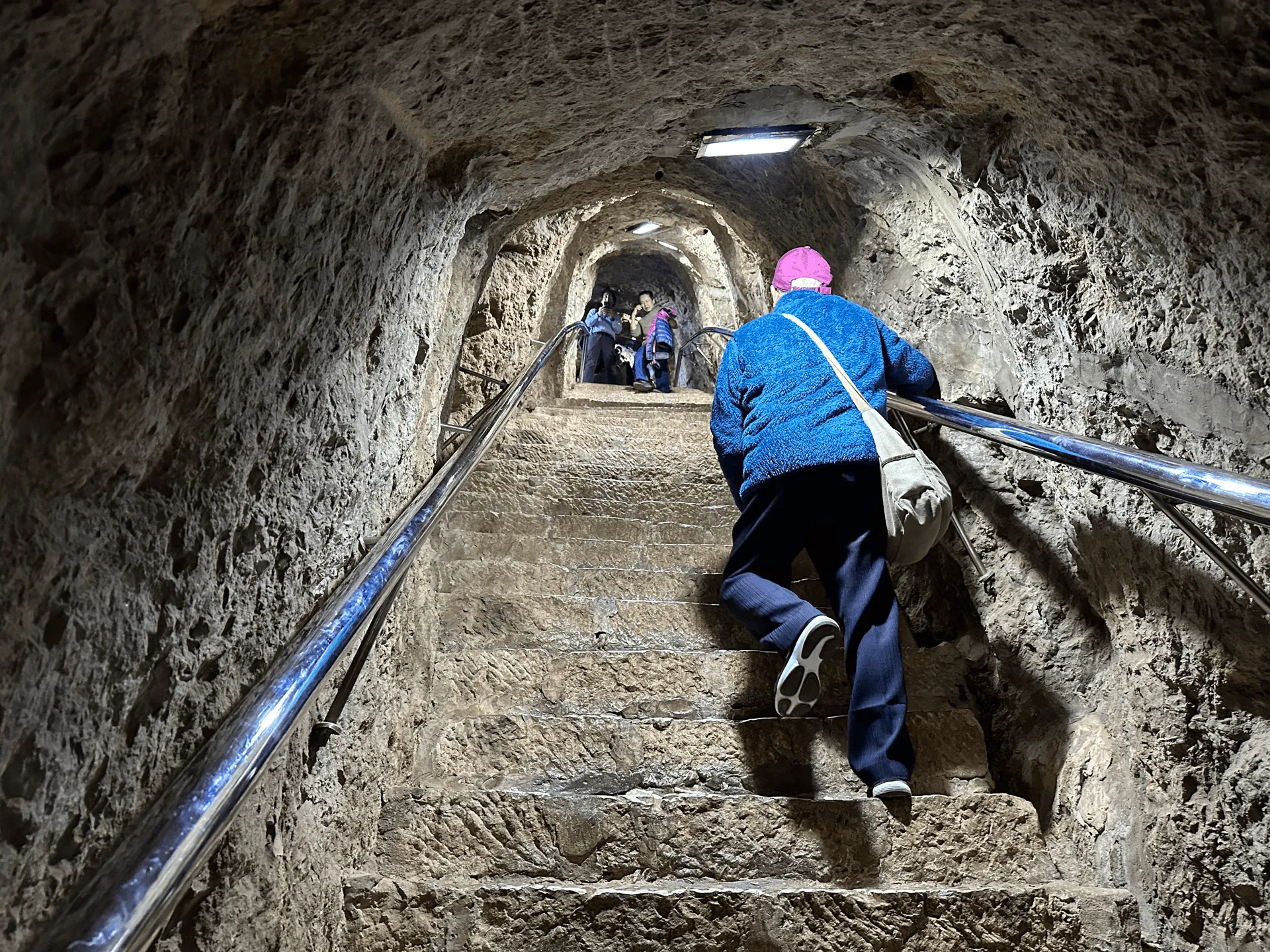 A steep tunnel carved through the rock with stairs