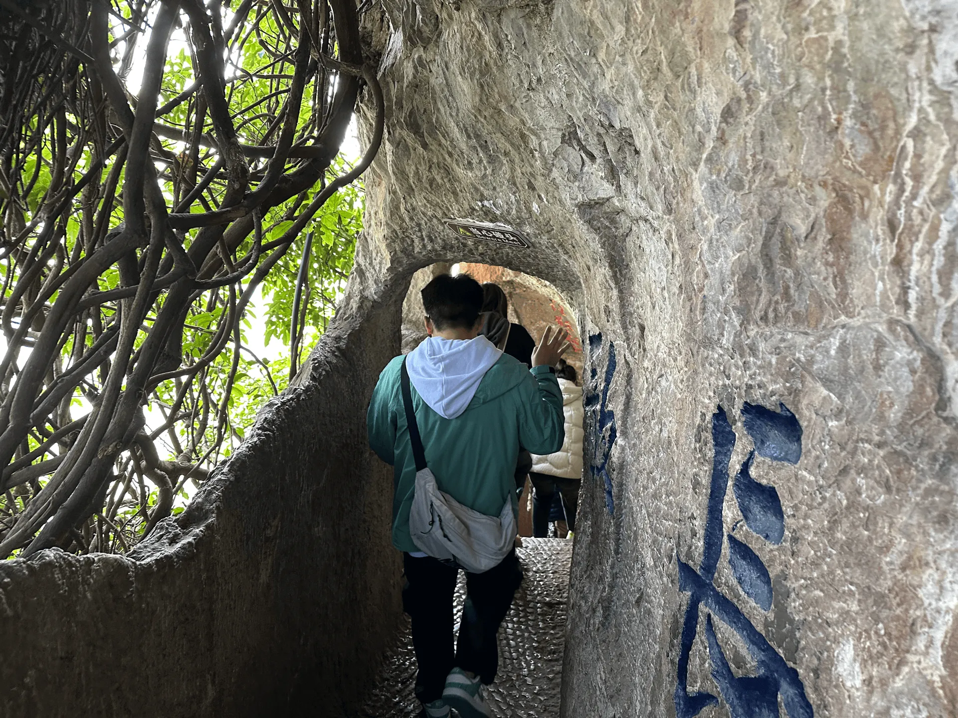 A narrow tunnel carved through the mountain rock